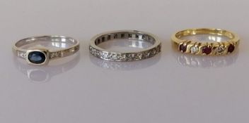A sapphire and diamond ring, the central oval-cut sapphire weighing approximately 0.33 carats