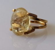 An oval citrine dress ring in a yellow gold setting, the faceted citrine 20 x 16mm, size, M, stamped
