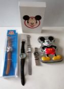 A vintage manual wind Mickey Mouse watch, Poo Bear, a cased Looney Tunes Disney watch and two other
