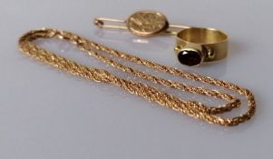 An artisan gold band with oval set garnet, 8 x 5mm, unmarked with tests for 9ct gold, size M1/2;