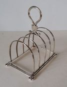 A Victorian silver four-slot toast rack on ball feet by Walter & John Barnard, London, 1882, 15 H x