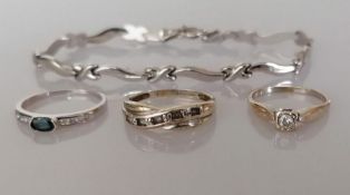 An 18ct white gold oval-cut sapphire ring, 2.3g and two 9ct white gold diamond rings