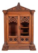 A Victorian carved oak gun cabinet in Gothic style,