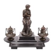 A Salmson bronze desk stand the central figure of a robed female holding a bird to her breast,