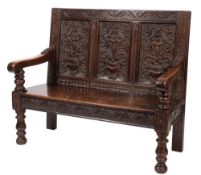 A carved oak settle in Baroque taste,