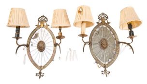 A pair of 19th century gilt metal girandoles with oval mirrored backplates centered with an oval