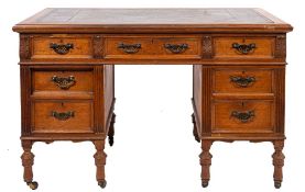 A Victorian oak pedestal desk, by James Shoolbred & Co,, London,