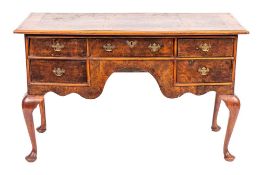 A burr walnut writing desk in George II style, elements 18th century and later,