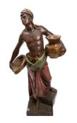 A large polychrome plaster model of a male Nubian servant carrying a vase under one arm and a bowl