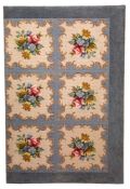 A large gross-point woolwork headboard of rectangular outline with six panels of Berlin work style