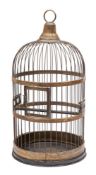 A brass bird cage of cylindrical outline with domed top and suspension loop,
