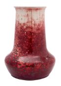 A large Ruskin high-fired vase with tapering neck and flared rim, covered in a flambé,
