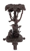 A central European, probably 'Black Forest' carved and stained wood jardiniere stand,