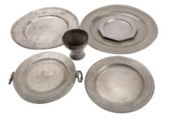 A small group of pewterwares includes;- a late 18th century English pewter charger, 38cm diameter,