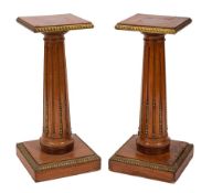 A pair of mahogany and gilt metal mounted columnar lamp stands in Louis XVI taste,