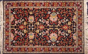 A Kashmiri rug:, the shaded field with an all over design of palmettes,