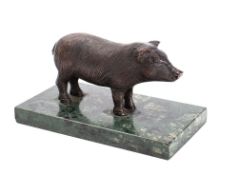 A bronze model of a pig mounted on a polished variegated green marble base, unsigned 17.5cm long.