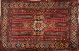 A Shiraz carpet, the shaded rose rectangular field with a central beige octagonal pole medallion,