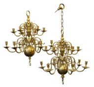 A pair of early 19th century brass fourteen branch chandaliers in the Dutch taste with two tiers of