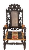 A Victorian carved and ebonised oak elbow chair in 17th century style,