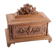 A Black Forest carved linden wood casket of rectangular outline,