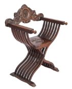 An Italian carved walnut Savanarola elbow chair,