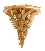 A 19th century giltwood wall bracket the shelf of bowed outline with reeded border,