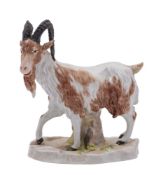 A Continental figure of a goat in the Meissen manner naturalisically modelled and on tree stump