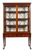 A mahogany glazed display cabinet on stand in George II taste,
