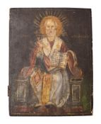 A late 19th century Greek icon depicting a seated Saint Nicholas giving a blessing whilst holding a