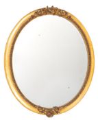 A Victorian giltwood and composition framed oval wall mirror in Roco Revival style,