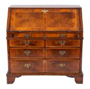 A George II walnut and feather banded bureau, circa 1740,