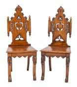 A pair of Victorian carved oak hall chairs in flamboyant Gothic style, third quarter 19th century,