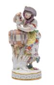 A Meissen figure of a girl vintner modelled after the original by Michael Victor Acier wearing a