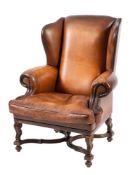 A leather upholstered wing armchair in Queen Anne/ early George I taste,