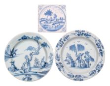 Two English blue and white delftware plates and a similar tile both plates painted with a Chinese