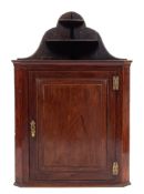 A George III mahogany hanging corner cabinet.