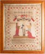 A Victorian Silkwork sampler 'Our Saviour Dying' with central crucifixion scene with verse,