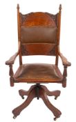 An Edwardian oak swivel desk chair,