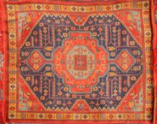 A Turkoman Rug, the brick red field with a central ivory and indigo geometric medallion,