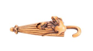 A Japanese boxwood netsuke of two rats, one emerging from an umbrella, unsigned, 9cm long.