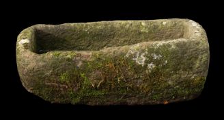 A rough hewn limestone trough, 18th or 19th century; of loosely rectangular form; 37cm high,