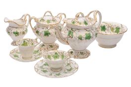 An H & R Daniel porcelain part tea service of moulded rococo form enamelled with green vines