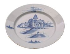 An English blue and white delftware dish painted with a fisherman on a bridge,