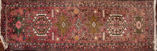 A Hamadan Runner, the rose field with a row of geometric medallions,