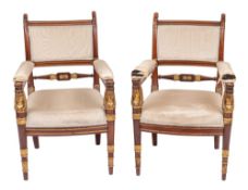 A pair of fine late Empire or Restauration mahogany and parcel gilt fauteuils,