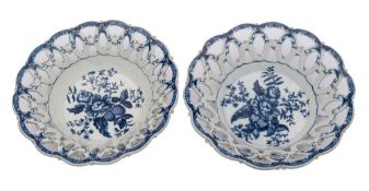 A pair of First Period Worcester blue and white baskets of conventional form with applied florets