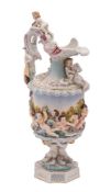 A German porcelain ewer in Capodimonte style relief moulded with mythical figures,