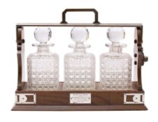 A George V oak and silver mounted presentation tantalus of rectangular outline,