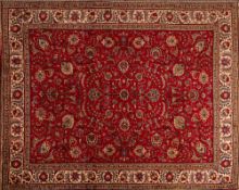 A Tabriz Carpet, the wine field with an all over design of palmettes and scrolling floral foliage,